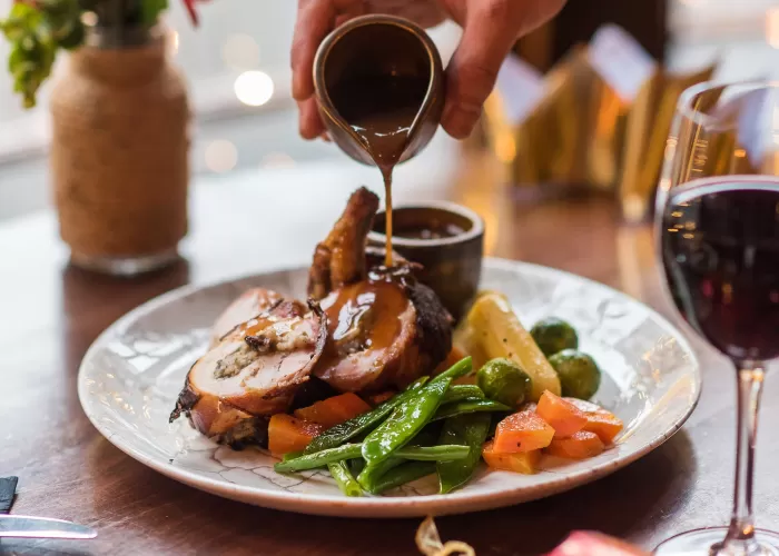 A stuffed chicken Christmas main course served at bay window table of Barnstaple Restaurant 62 The Bank